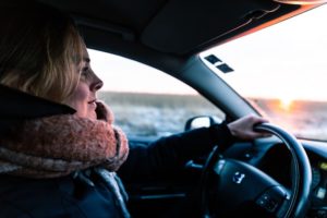 woman driving car in winter weather