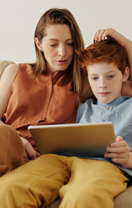 mother uses tablet with son