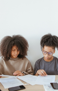 two high school students review paperwork together